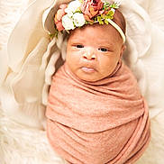 Kru is registered to the contest to win money with this photo: newborn, baby, swaddled, blanket, flower_headband, floral, portrait, soft_texture, infant, cute, wrapped, peaceful, white_background, flower_petals, closeup, adorable, headband, baby_face, soft_lighting, cozy