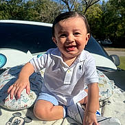 Ernesto joined the competition — help win amazing prizes! toddler, child, smiling, white_polo, shoes, blanket, mickey_mouse, outdoor, sunlight, trees, car, happy, face, sitting, blue_sky, grass, cute, person, baby, nature