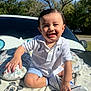 toddler, child, smiling, white_polo, shoes, blanket, mickey_mouse, outdoor, sunlight, trees, car, happy, face, sitting, blue_sky, grass, cute, person, baby, nature