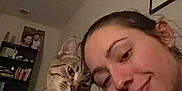 Lola joined the competition — help win amazing prizes! affection, bookshelf, casual, cat, closeup, collar, cozy, face, furniture, head, human, indoor, pet, picture_frame, plant, portrait, shelf, smile, tabby_cat, woman