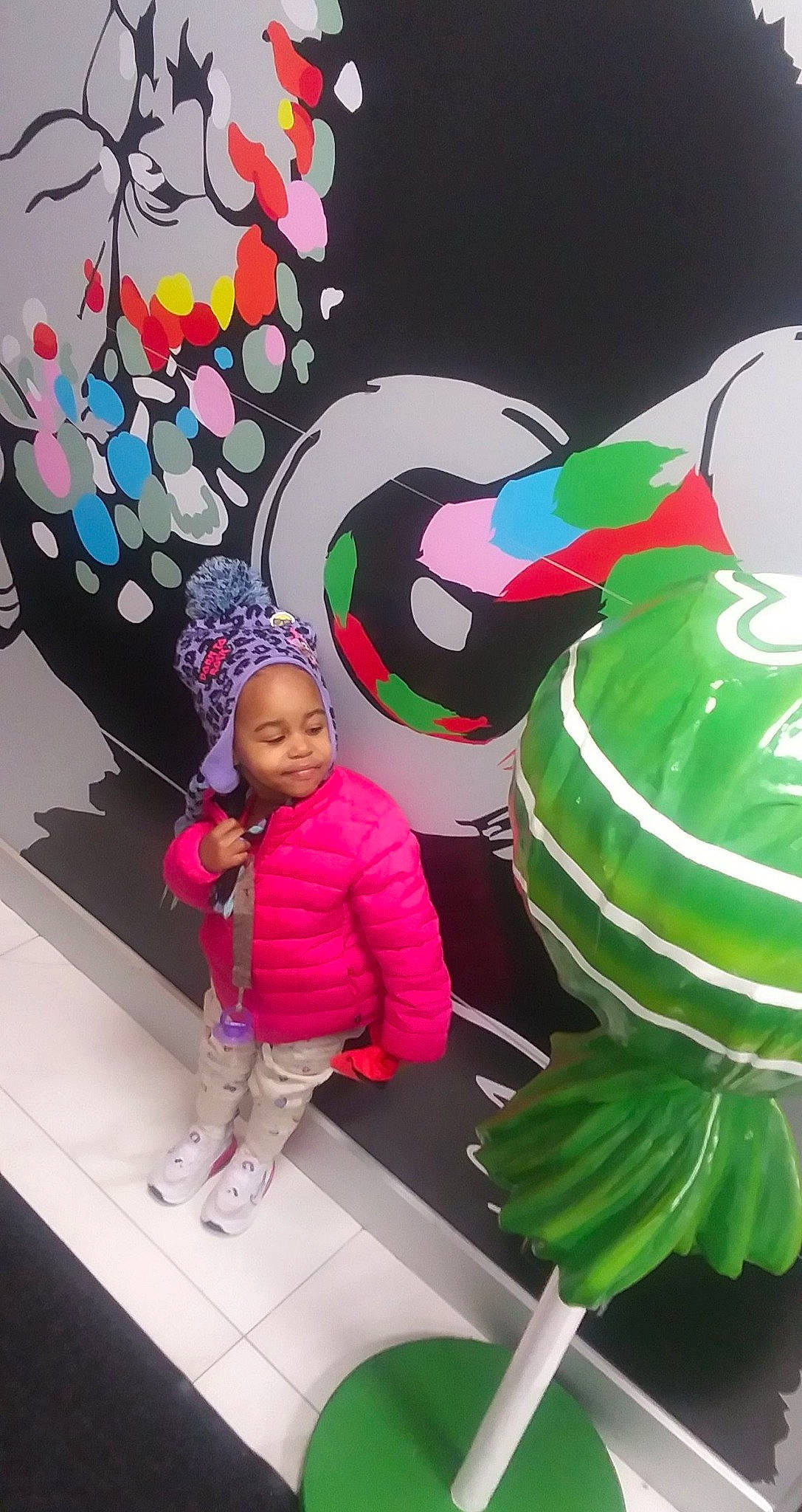 Spirit is registered to the contest to win money with this photo: art, baby, child, event, fictional_character, fun, green, hat, headgear, headwear, holiday, joy, magenta, organism, party_supply, pattern, person, pink, plant, snapshot