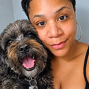 Snickers joined the competition — help win amazing prizes! woman, person, dog, pet, selfie, portrait, smiling, happy, scruffy_dog, black_and_gray_fur, tongue, collar, harness, pet_tags, hoop_earring, nose_piercing, curly_hair, indoor, close_up, companion