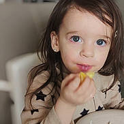 Shéryne participe au concours pour gagner de l'argent avec cette photo : blue_eyes, bowl, casual, child, clothing, curious, earrings, eating, face, food, hand, indoor, long_hair, meal, person, portrait, rice, star_pattern, toddler, vegetables