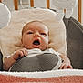 Arwen is registered to the contest to win money with this photo: baby, infant, baby_seat, cushion, plush_toy, soft_texture, hand, face, mouth_open, indoors, child, newborn, comfort, expression, cute, resting, fabric, closeup, seat, person