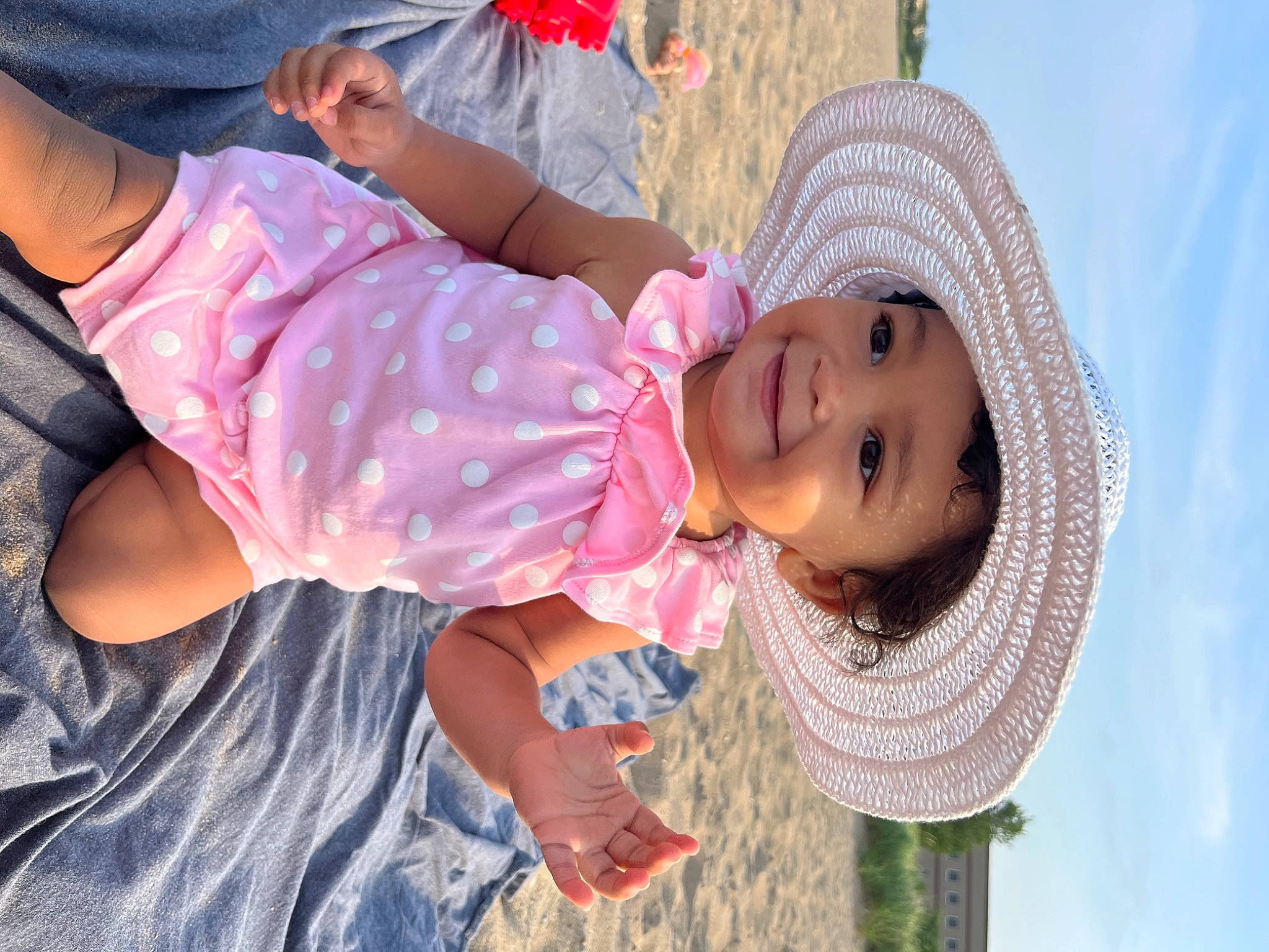 Layla joined the competition — help win amazing prizes! baby, baby_toddler_clothing, child, clothing, fashion_accessory, fun, gesture, grass, hand, happy, hat, headwear, joy, leisure, people_in_nature, person, pink, skin, sky, smile