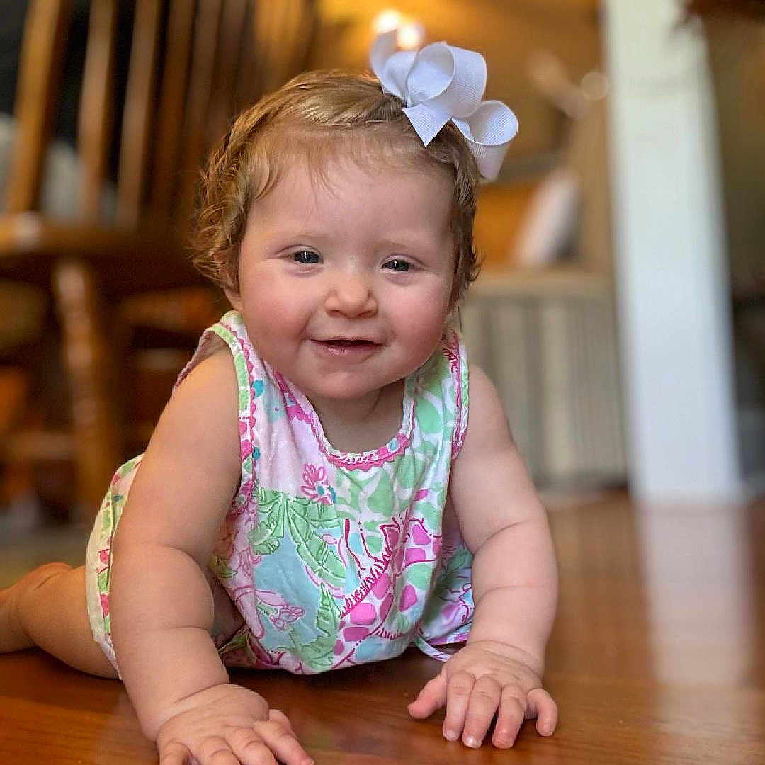 Faylen is registered to the contest to win money with this photo: accessories, baby, babycrawling, clothing, crawling, dress, face, hardwood, head, jewelry, necklace, person, photography, portrait, sitting, wood