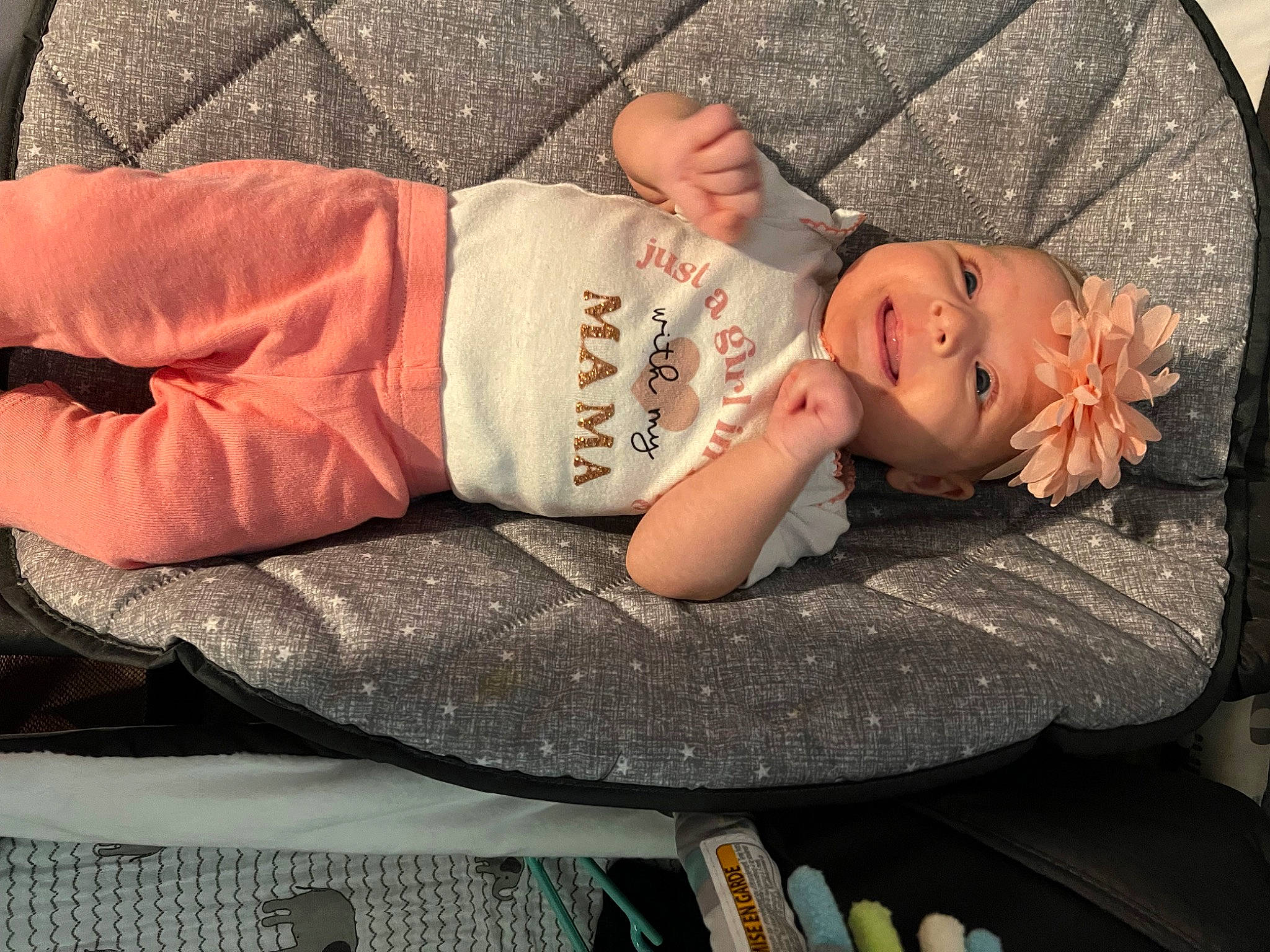 Bristol is registered to the contest to win money with this photo: baby, baby_products, baby_toddler_clothing, child, comfort, doll, dress, fashion_accessory, grass, hand, hat, head, headpiece, headwear, human_body, jewellery, nap, pattern, person, petal