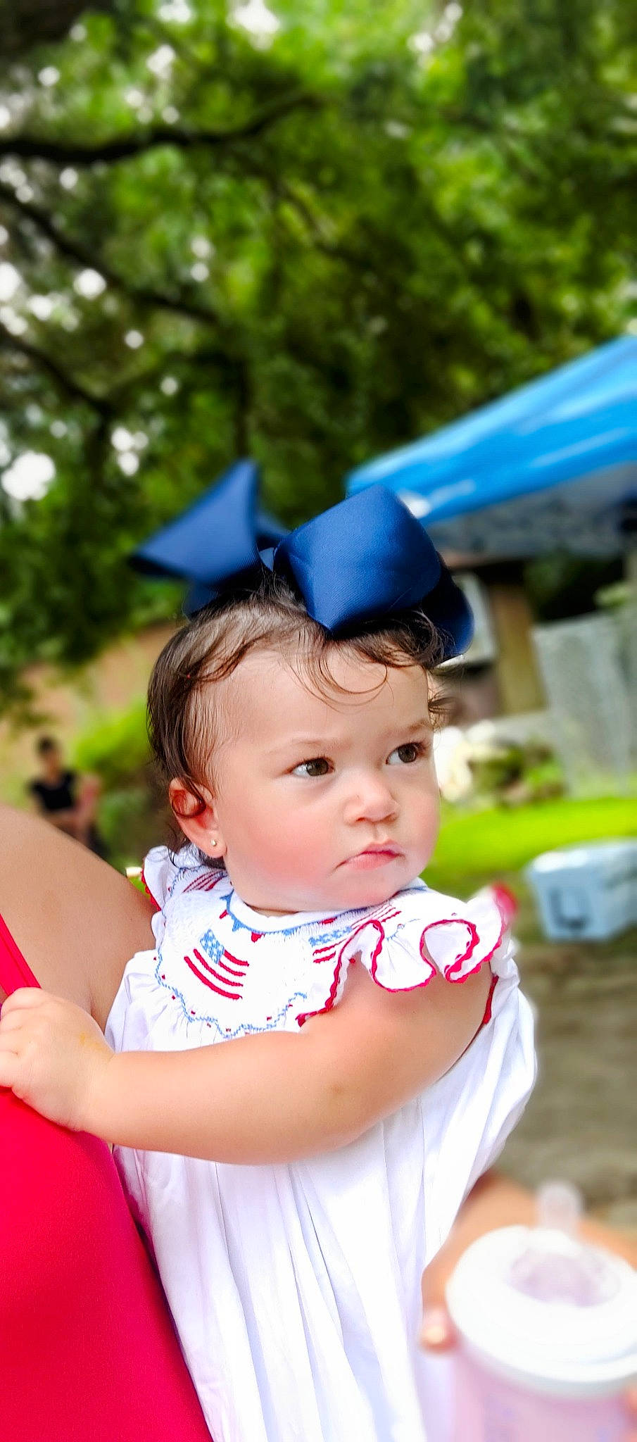 Madison is registered to the contest to win money with this photo: baby, baby_toddler_clothing, blue, child, electric_blue, event, fashion_accessory, fun, grass, happy, leisure, people_in_nature, person, portrait_photography, recreation, sitting, toddler, tree, vacation