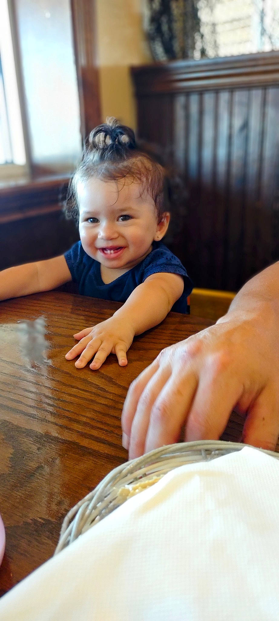 Madison is registered to the contest to win money with this photo: baby_toddler_clothing, child, cup, dishware, drinkware, face, finger, flooring, happy, hardwood, head, joy, person, serveware, skin, smile, table, tableware, thumb, toddler