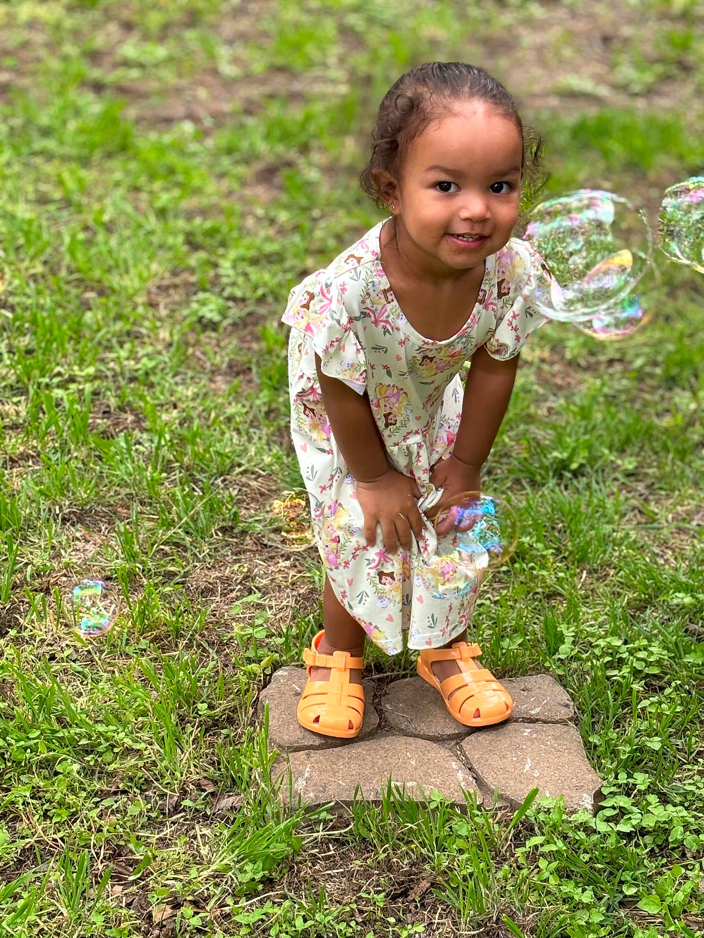 Zaya joined the competition — help win amazing prizes! child, clothing, dress, face, female, footwear, girl, grass, head, nature, outdoors, person, photography, plant, portrait, rock, sandal, sitting, sleeve, standing
