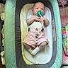 baby, pacifier, infant, pink_shorts, baby_lounger, blanket, toy, cushion, white_socks, clothing, lying_down, indoor, child, person, cute, small, comfortable, looking_up, home, nursery