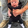 Raelynn joined the competition — help win amazing prizes! baby, infant, child, hands, tattoos, jeans, shoes, black_outfit, white_socks, floor, person, holding, expression, face, portrait, standing, cute, outdoor, casual, skin