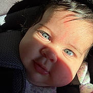 Cattaleya is registered to the contest to win money with this photo: baby, blue_eyes, close_up, car_seat, child, face, floral_outfit, infant, light_and_shadow, looking_at_camera, portrait, sitting, straps, young_child, cute, skin, hair, expression, daylight, indoors