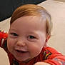 Malakai is registered to the contest to win money with this photo: toddler, child, smiling, happy, face, close_up, red_clothing, cartoon_print, indoors, cute, baby, joyful, young_child, portrait, light_brown_hair, expression, reaching_hand, person, head, cheerful