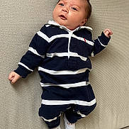 Milan a rejoint le concours — aidez-le/la à gagner de superbes lots ! baby, child, couch, cozy, expression, face, feet, hands, head, indoor, infant, looking_up, lying_down, navy_stripes, onesie, portrait, socks, striped_clothing, upholstery, white_stripes