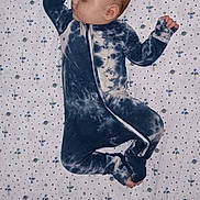 Sonny joined the competition — help win amazing prizes! baby, sleeping, onesie, tie_dye, bed, sheet, space_pattern, stars, planets, rocket, infant, child, peaceful, cute, pajamas, sleepwear, portrait, rest, indoors, blanket