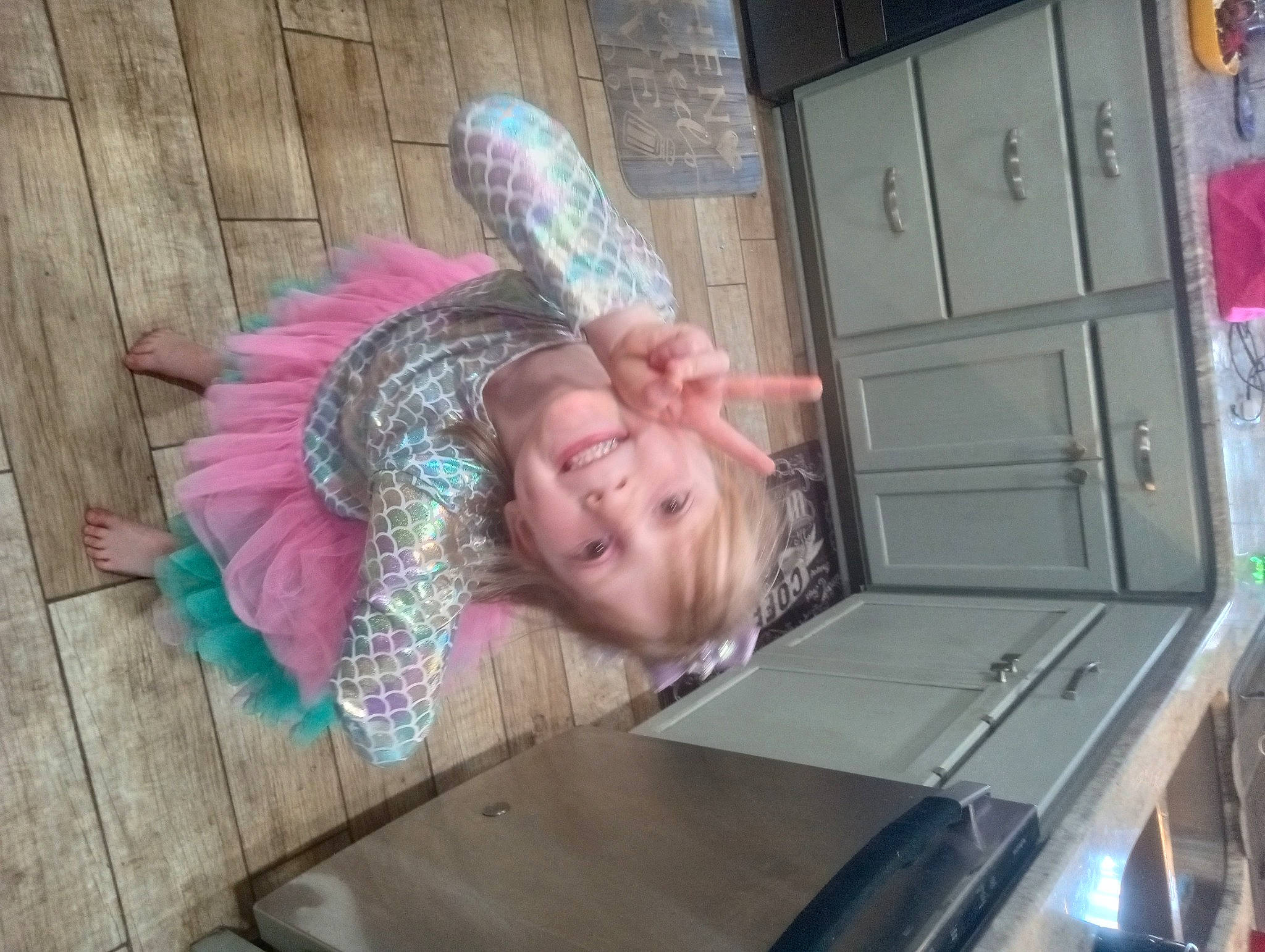 Rose is registered to the contest to win money with this photo: automotive_exterior, child, drawer, fashion_accessory, flooring, fun, happy, joy, leisure, magenta, motor_vehicle, person, pink, room, smile, t_shirt, table, toddler, umbrella, vehicle_door