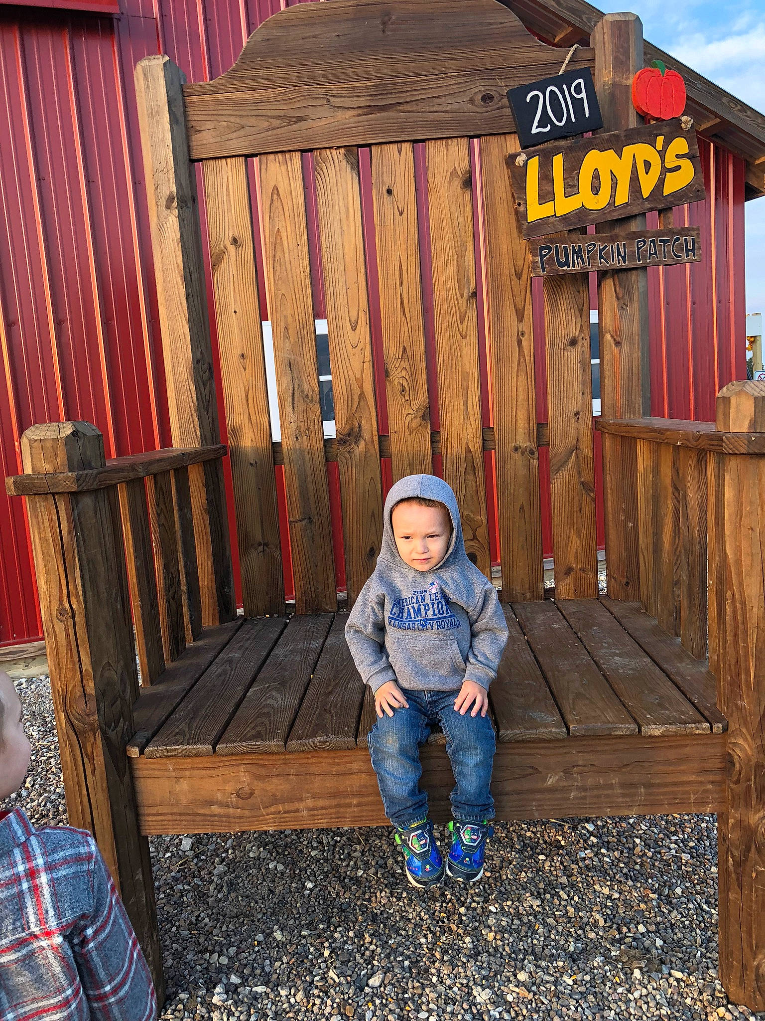 Kilynn joined the competition — help win amazing prizes! baby_toddler_clothing, building, child, comfort, cottage, fun, grass, hardwood, headwear, house, jacket, leisure, mammal, outdoor_furniture, outerwear, person, public_space, sky, smile, standing