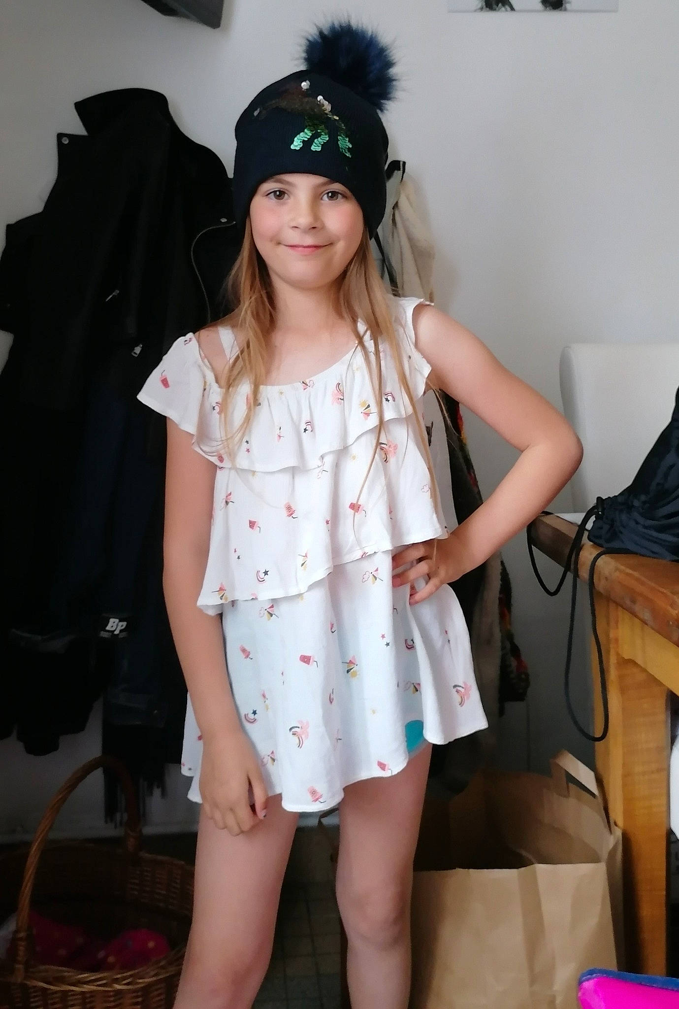 Luna participe au concours pour gagner de l'argent avec cette photo : black_hair, cap, child, day_dress, dress, fashion, fashion_design, hair, headwear, human_leg, jewellery, joy, knee, long_hair, necklace, pattern, person, skin, sleeve, smile