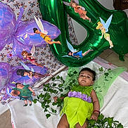 Sofia joined the competition — help win amazing prizes! baby, toddler, costume, tinkerbell, fairy, balloon, green, purple, leaves, blanket, floor, decoration, party, child, person, indoor, cute, celebration, magic, fantasy