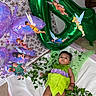 baby, toddler, costume, tinkerbell, fairy, balloon, green, purple, leaves, blanket, floor, decoration, party, child, person, indoor, cute, celebration, magic, fantasy