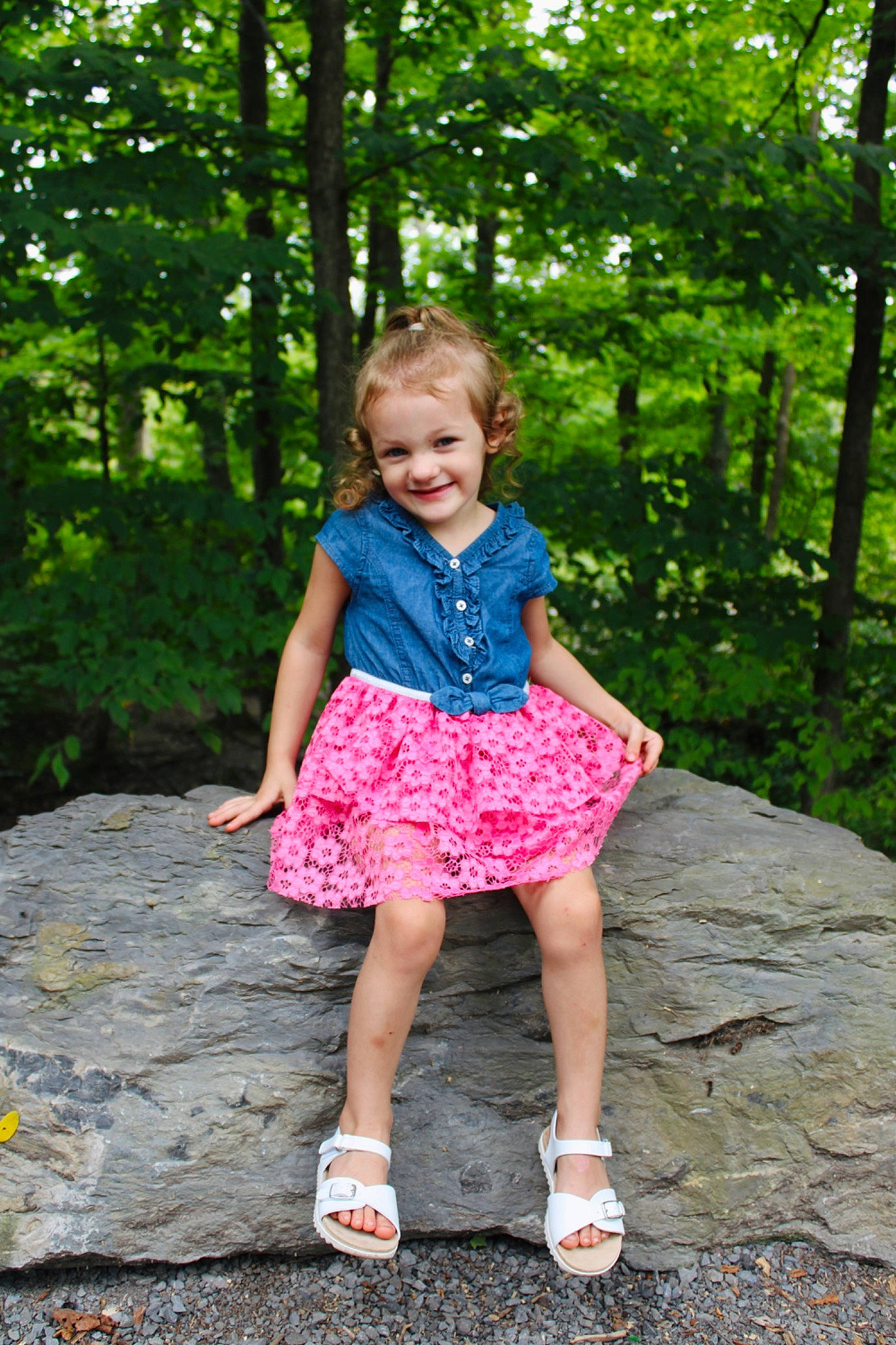 Genevieve is registered to the contest to win money with this photo: baby_toddler_clothing, child, forest, fun, grass, happy, joy, leisure, magenta, pattern, people_in_nature, person, plant, recreation, sitting, smile, spring, summer, toddler, tree