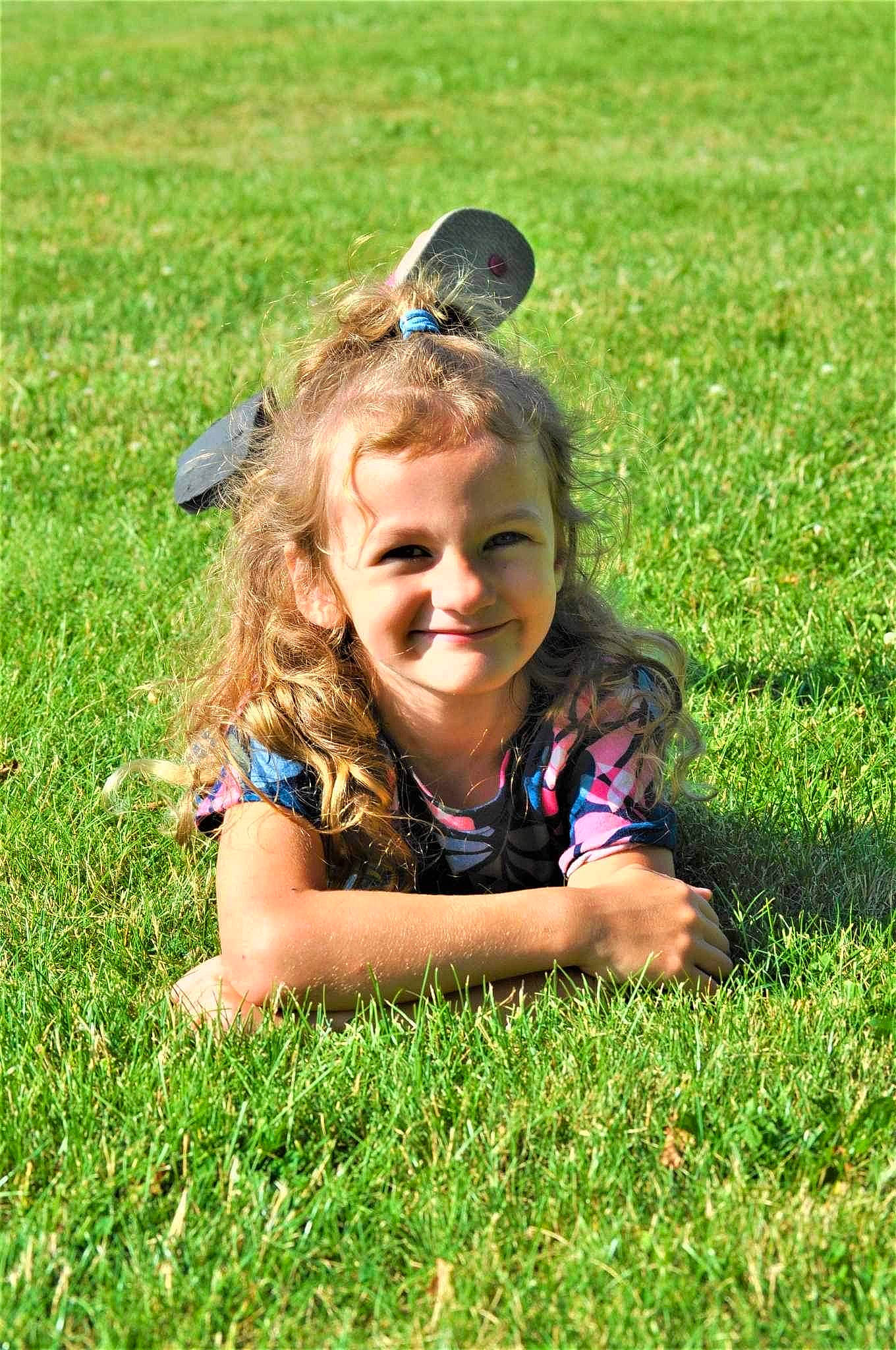 Genevieve joined the competition — help win amazing prizes! ecoregion, fun, grass, grass_family, grassland, happy, human_body, joy, lawn, leisure, meadow, nature, people_in_nature, person, plant, smile, summer, sunglasses, sunlight, toddler