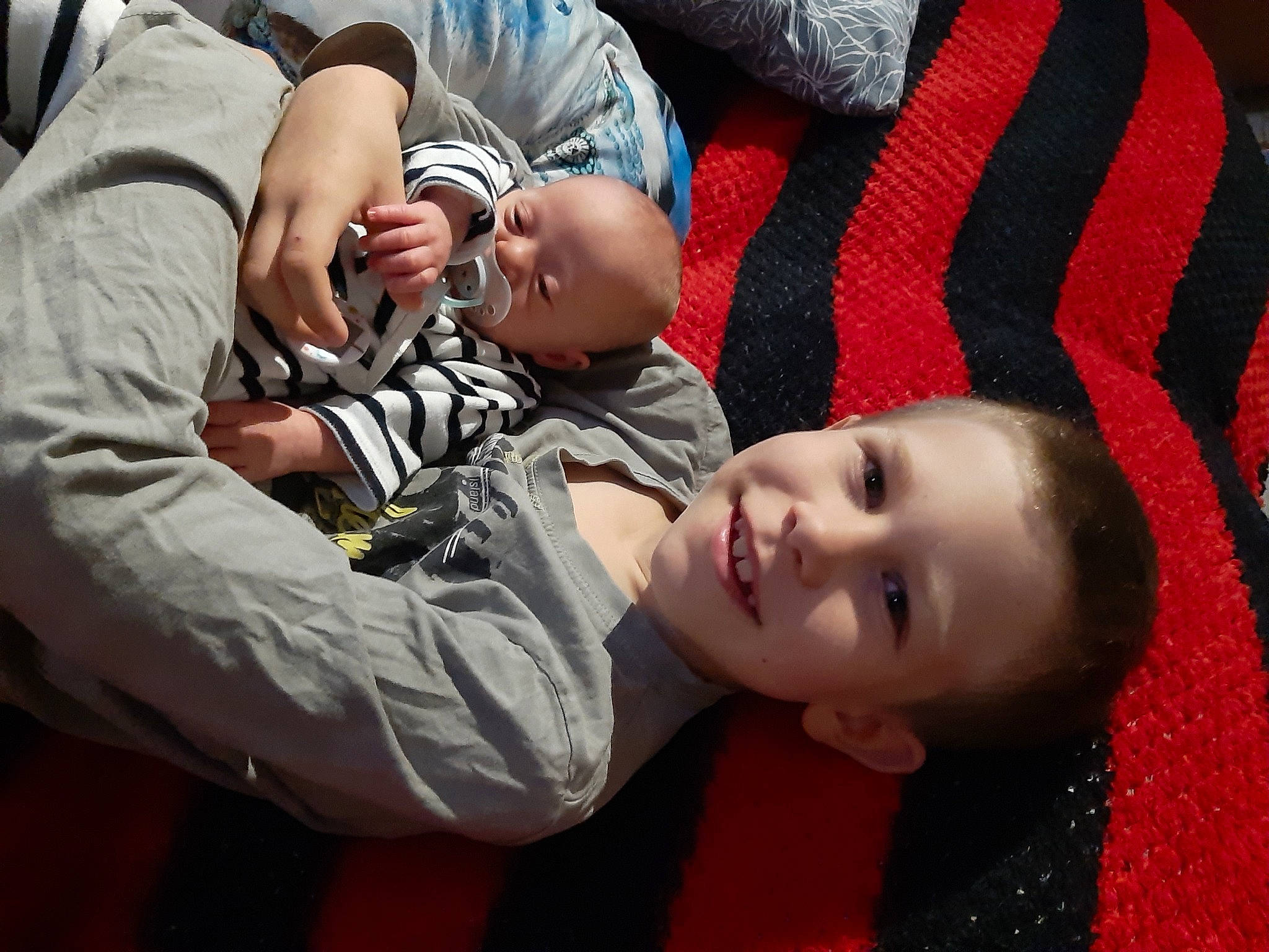 Hayden participe au concours pour gagner de l'argent avec cette photo : baby, baby_products, child, comfort, cool, flooring, fun, gesture, grass, happy, joy, mammal, mouth, nap, pattern, person, plaid, sitting, smile, toddler