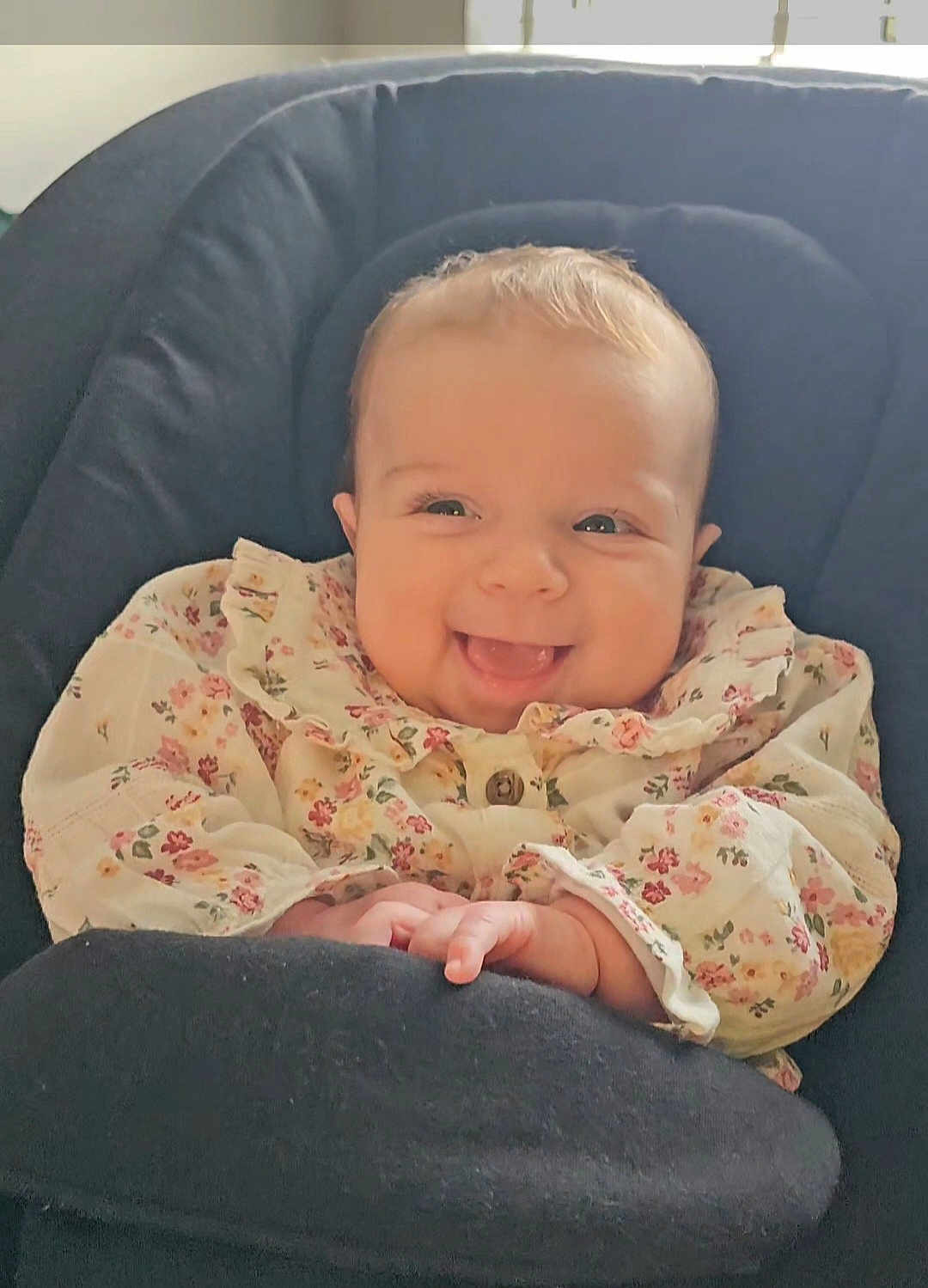 Bonnie joined the competition — help win amazing prizes! baby, smiling, infant, face, cute, child, clothing, floral, sitting, seat, cushion, happy, portrait, indoor, young_child, cute_outfit, hands, baby_girl, soft_lighting, closeup