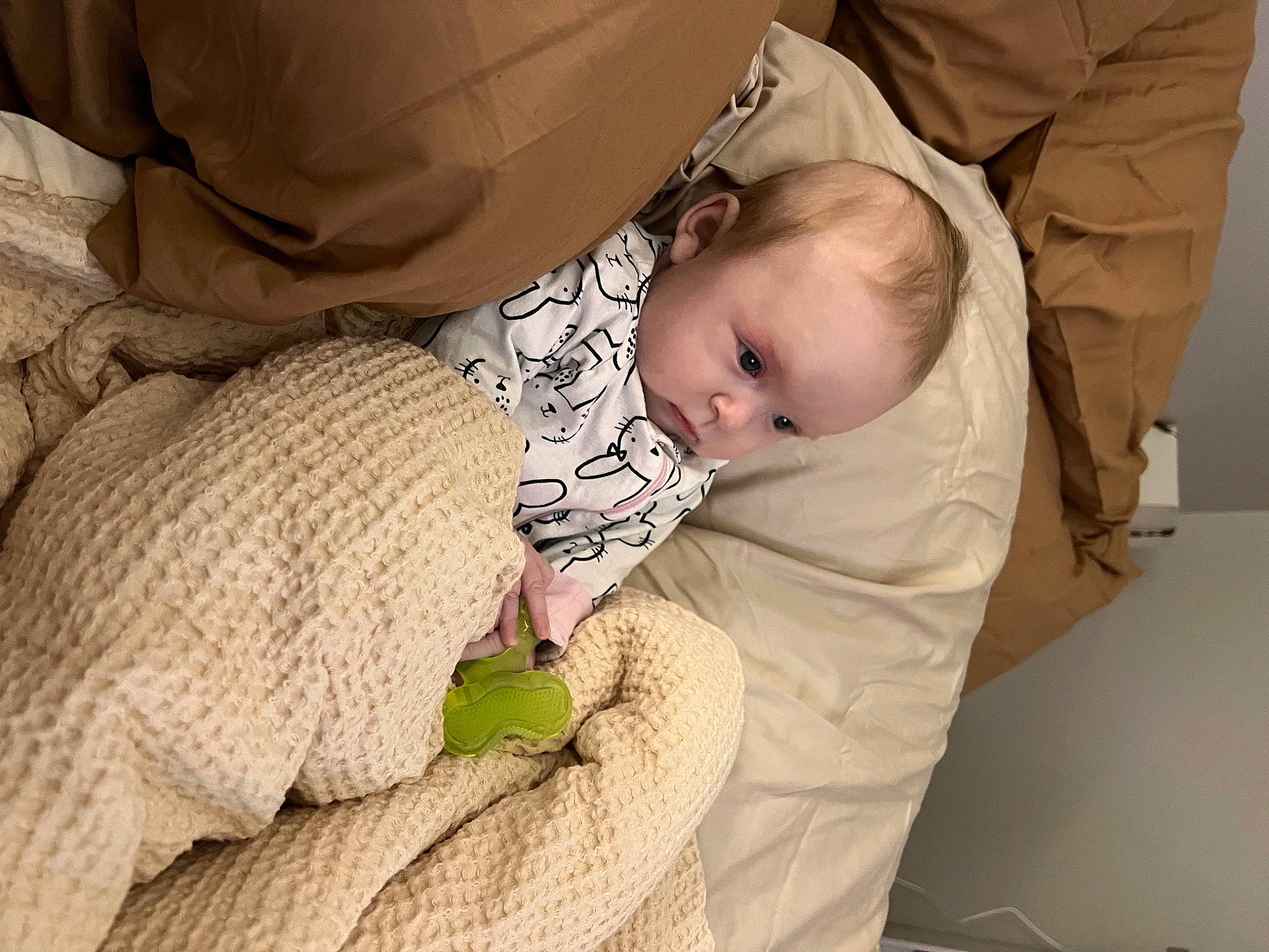 Amina is registered to the contest to win money with this photo: baby, baby_products, baby_safety, baby_sleeping, baby_toddler_clothing, bedtime, cheek, child, comfort, finger, human_body, linens, mouth, person, room, sitting, sleep, sleeve, toddler