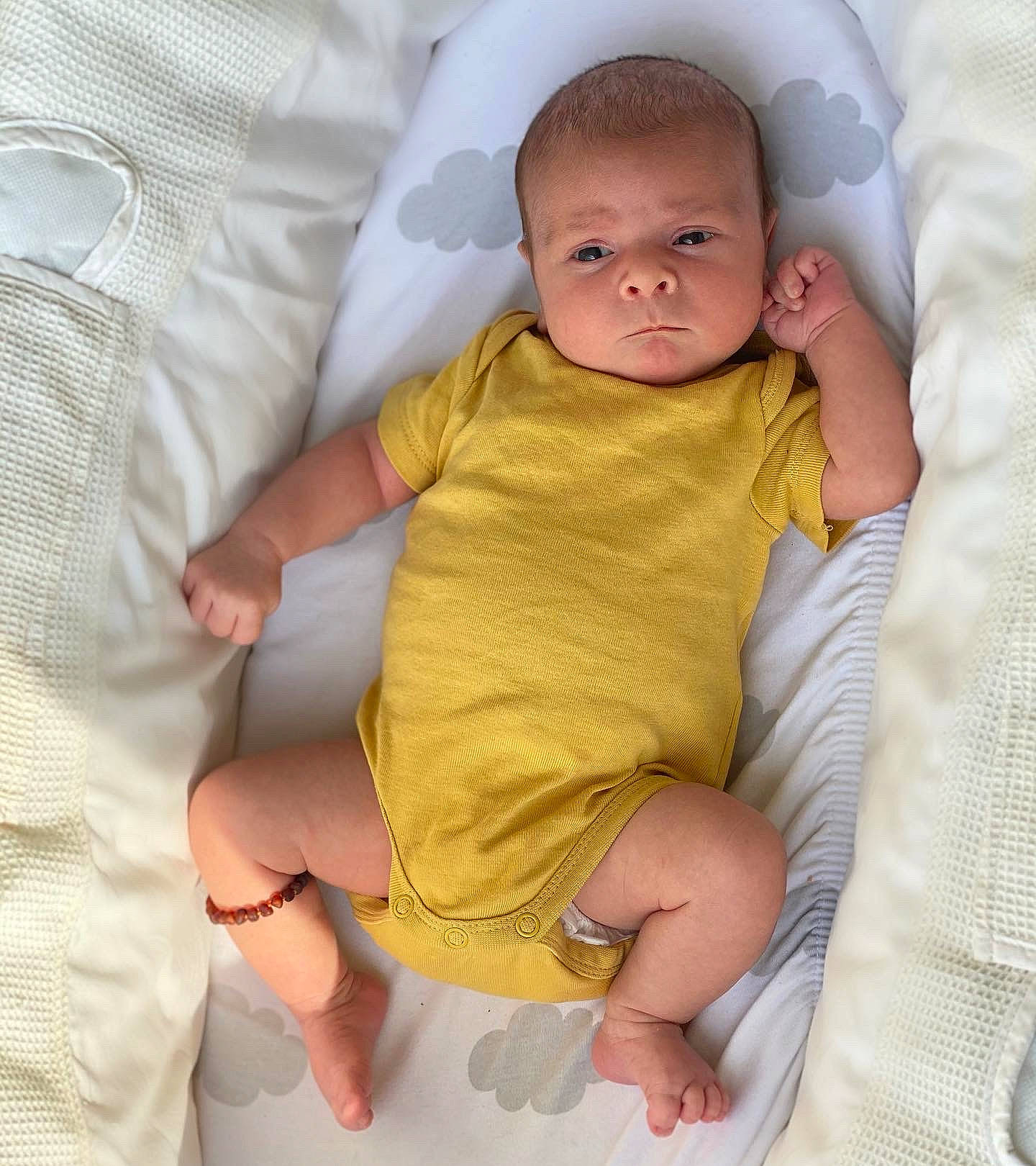 Ernie is registered to the contest to win money with this photo: baby, baby_toddler_clothing, cheek, comfort, eye, face, facial_expression, gesture, hand, head, human_body, leg, lip, mouth, neck, nose, person, skin, sleeve, stomach