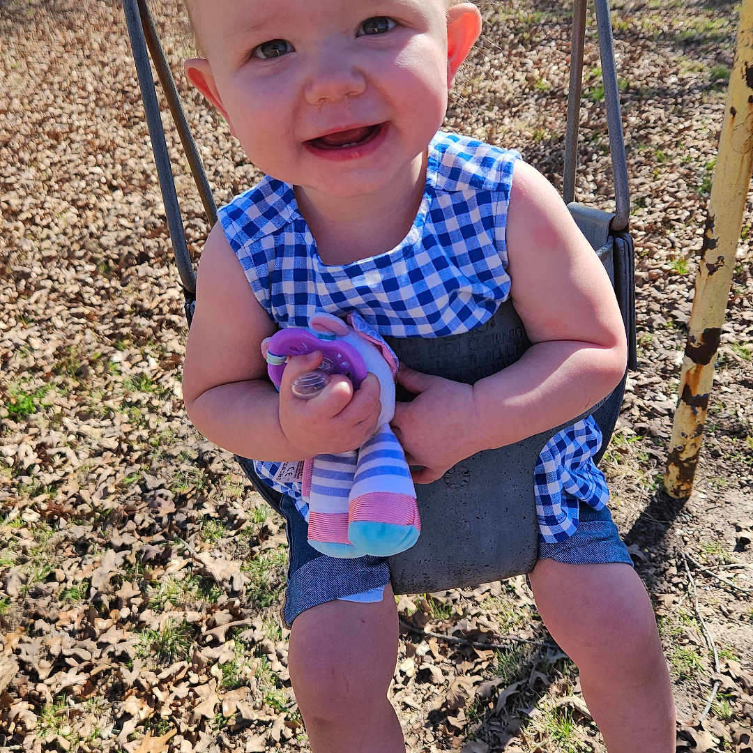 Zoey is registered to the contest to win money with this photo: baby, car, clothing, face, footwear, grass, head, nature, outdoorplayarea, outdoors, park, person, photography, plant, playarea, portrait, shoe, sneaker, transportation, vehicle