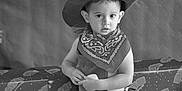 Théo participe au concours pour gagner de l'argent avec cette photo : bandana, black_and_white, child, clothing, costume, cow_print, cowboy_hat, curious, cute, fashion, hat, indoor, patterned_fabric, person, photo, portrait, serious_expression, standing, western, young_child