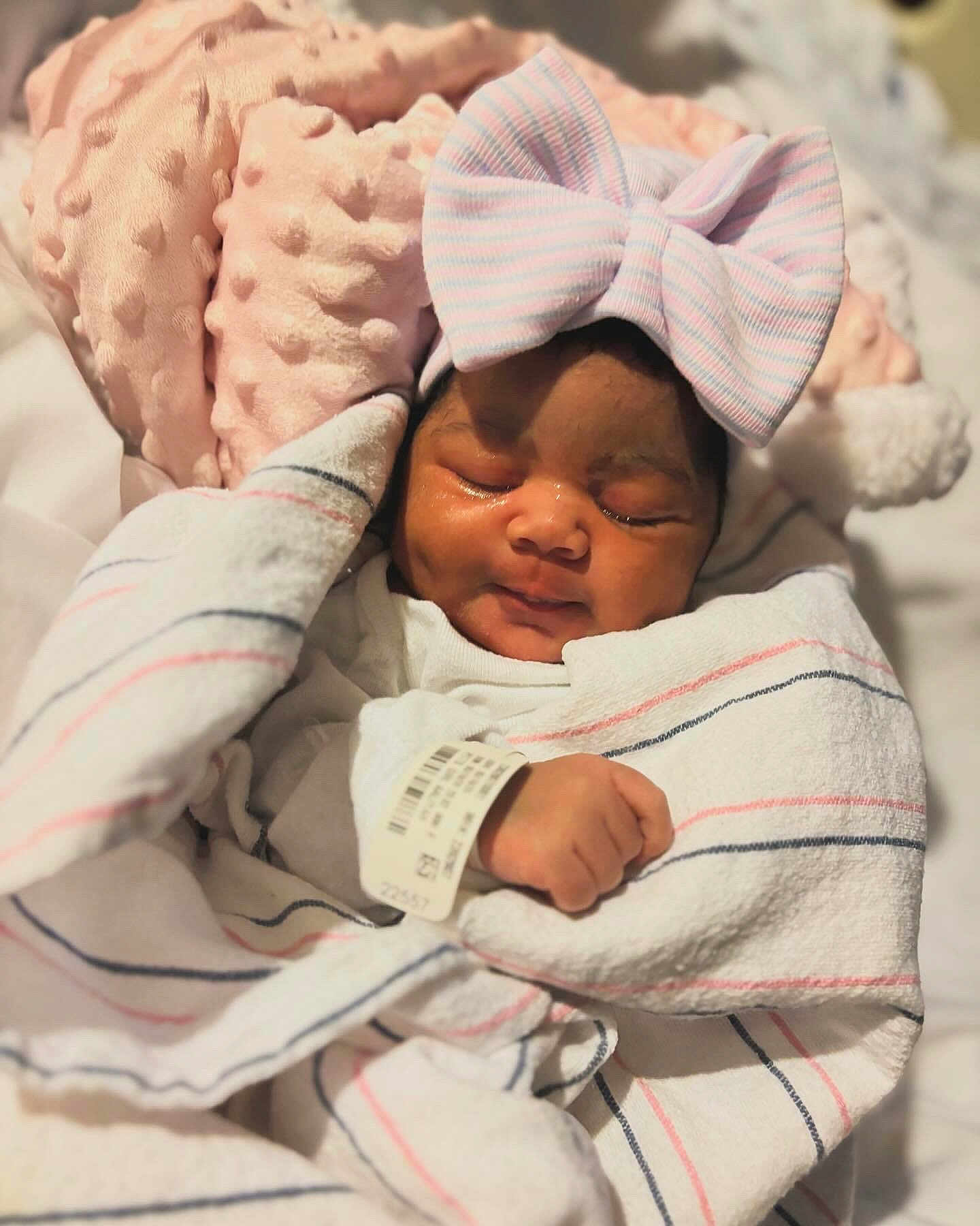 Normani joined the competition — help win amazing prizes! newborn, baby, sleeping, blanket, bow, pink, striped, hat, pillow, soft, cozy, wrapped, infant, cute, peaceful, resting, child, portrait, indoor, closeup