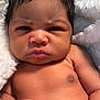 Normani joined the competition — help win amazing prizes! baby, infant, face, skin, hand, fist, blanket, newborn, expression, portrait, cute, child, young, human, closeup, soft, sleeping_area, bare_skin, tiny, adorable