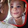 toddler, child, mirror, reflection, drool, face, curious, red_frame, indoors, window_light, close_up, cute, expression, clothing, infant, young_child, portrait, baby, looking, playful
