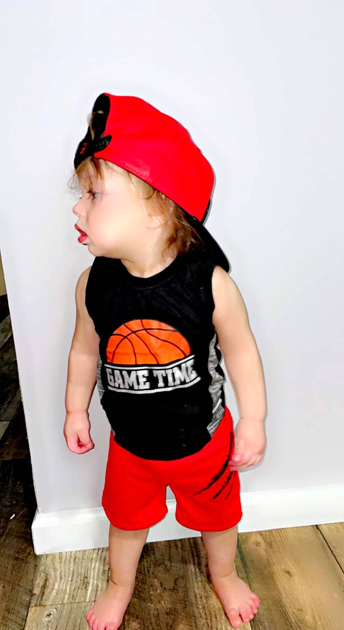 Elijah is registered to the contest to win money with this photo: baby, baby_toddler_clothing, baseball_cap, cap, child, costume, costume_accessory, fashion_accessory, goggles, headgear, human_leg, pattern, person, personal_protective_equipment, shorts, sleeve, sleeveless_shirt, t_shirt, thigh, toddler