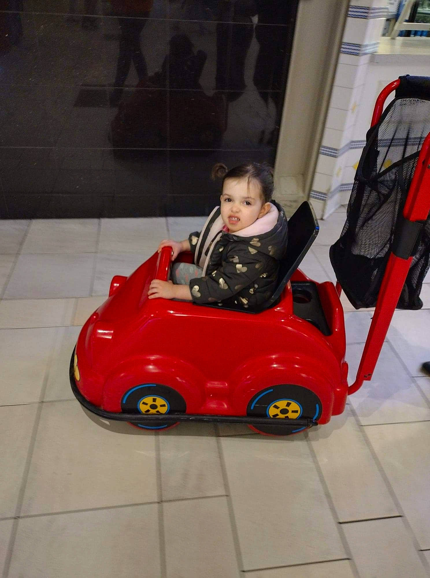 Angela is registered to the contest to win money with this photo: auto_part, automotive_design, automotive_exterior, automotive_tire, automotive_wheel_system, baby, baby_products, car, carmine, child, flooring, fun, motor_vehicle, person, recreation, riding_toy, tire, toddler, toy, vehicle