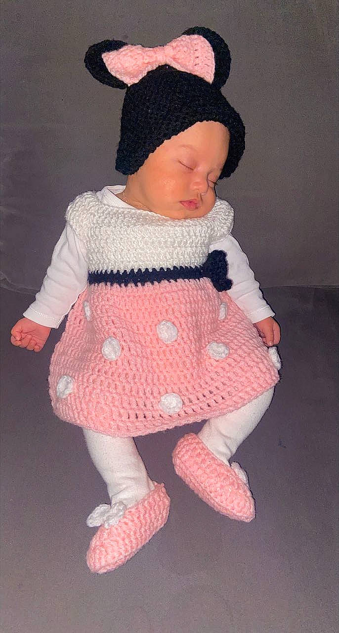 Lyaa participe au concours pour gagner de l'argent avec cette photo : arm, baby_toddler_clothing, creative_arts, day_dress, doll, dress, head, headgear, headwear, human_body, magenta, one_piece_garment, outerwear, pattern, person, pink, sleeve, sock, textile, toddler