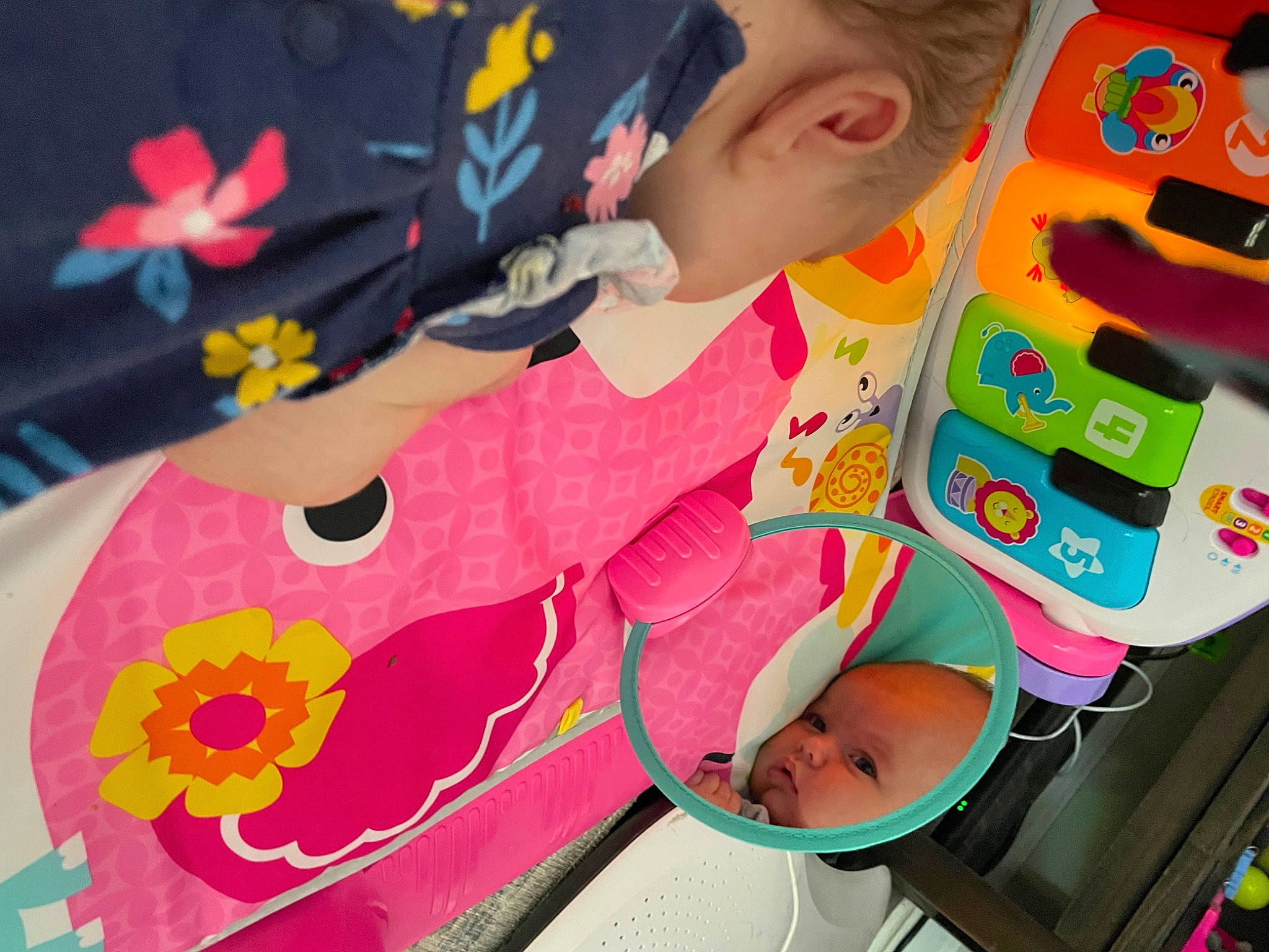 Emmie joined the competition — help win amazing prizes! baby_playing_with_toys, baby_products, baby_toys, child, flower, fun, happy, leisure, linens, magenta, pattern, person, petal, play, room, sandal, stuffed_toy, toddler, toy, visual_arts