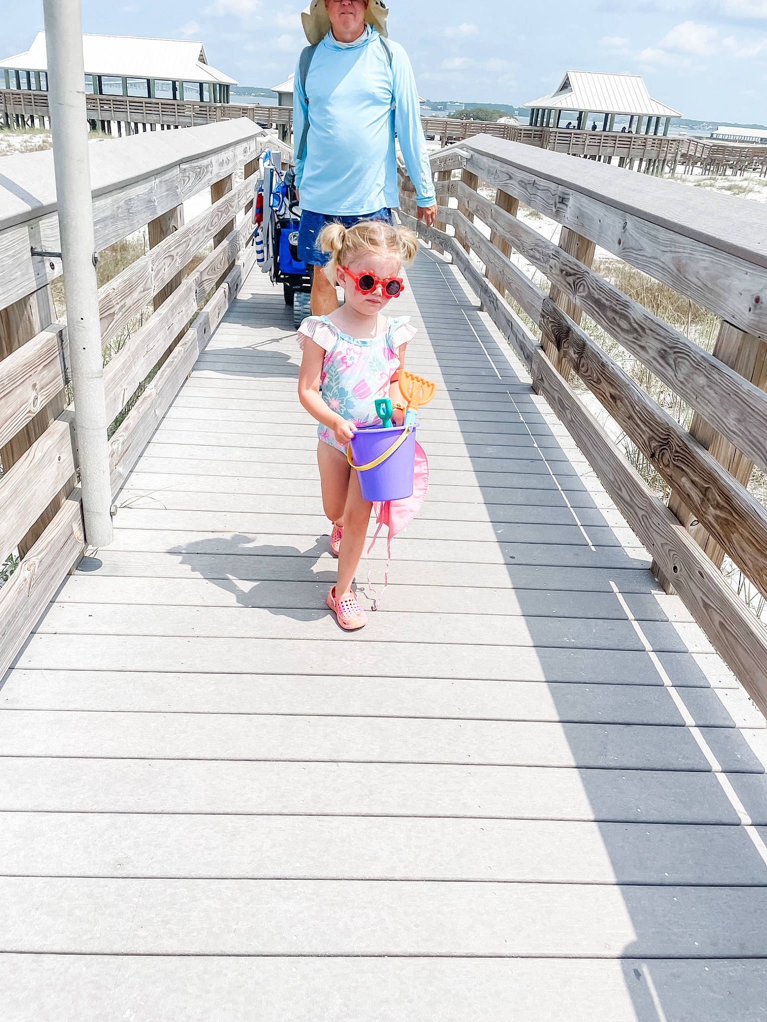 Winnie joined the competition — help win amazing prizes! boardwalk, cloud, dock, electric_blue, fun, happy, hat, human_leg, leisure, line, nonbuilding_structure, pedestrian, person, recreation, sky, sunglasses, thigh, toddler, travel, walkway