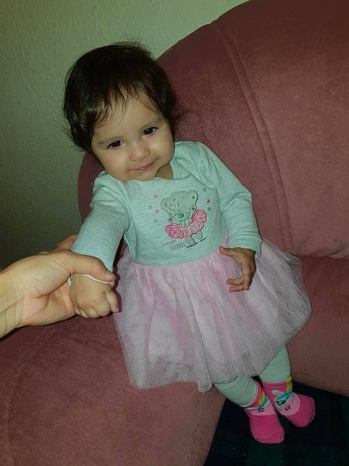 Mara is registered to the contest to win money with this photo: baby, baby_toddler_clothing, cheek, child, leg, person, pink, sitting, skin, toddler