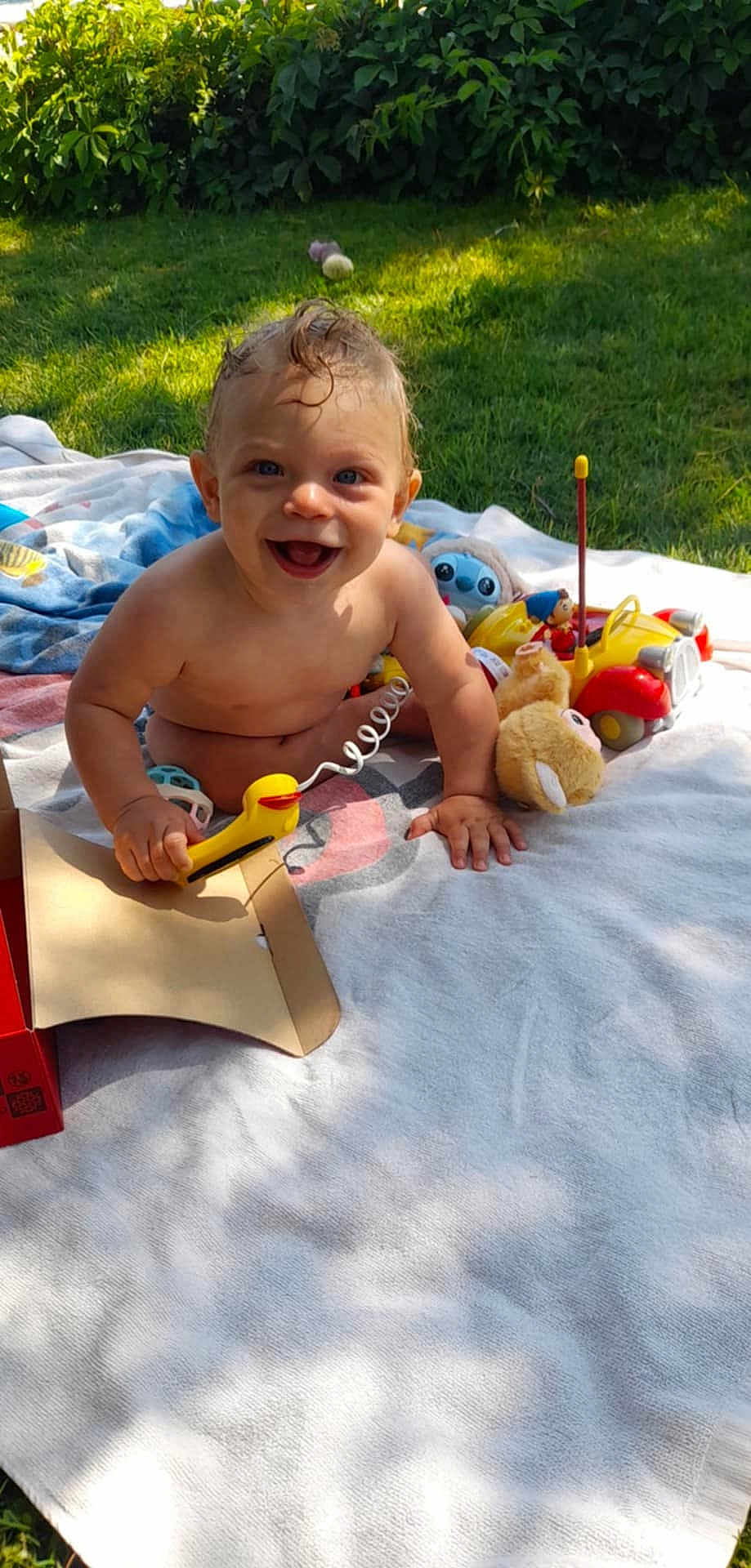 Florin participe au concours pour gagner de l'argent avec cette photo : baby, blanket, blue_eyes, child, cute, face, fun, grass, hand, happy, head, nature, outdoor, person, playtime, skin, smiling, summer, sunlight, toy