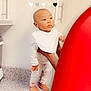 Isla joined the competition — help win amazing prizes! baby, child, toddler, kitchen, countertop, bib, pajamas, floral, barefoot, hands, adult, stove, cabinets, curious, standing, indoor, appliance, person, home, domestic