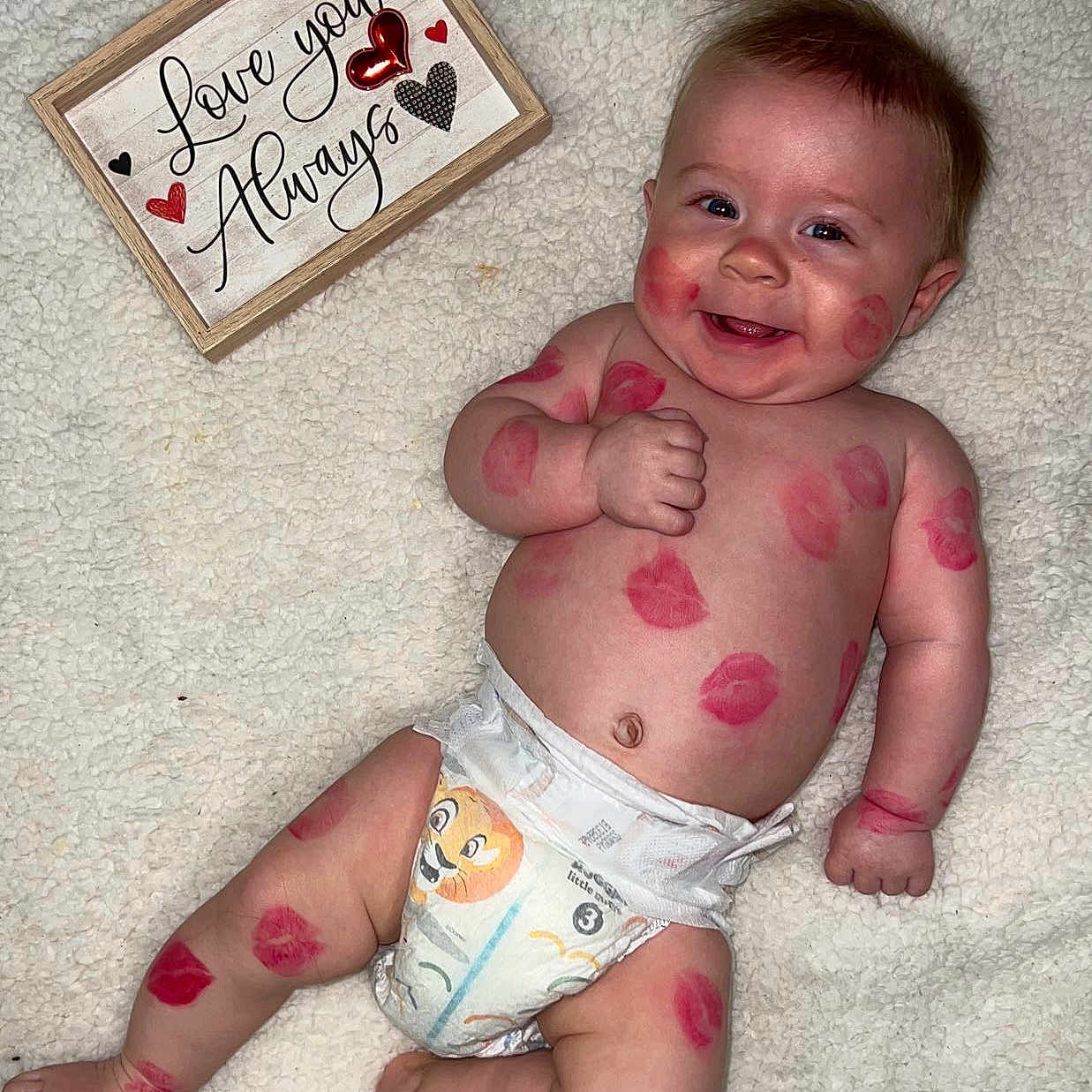 Kyler joined the competition — help win amazing prizes! baby, babylaughing, bodypart, clothing, diaper, face, finger, hand, happy, head, hosiery, laughing, newborn, person, photography, portrait, quilt, sitting, smile, sock