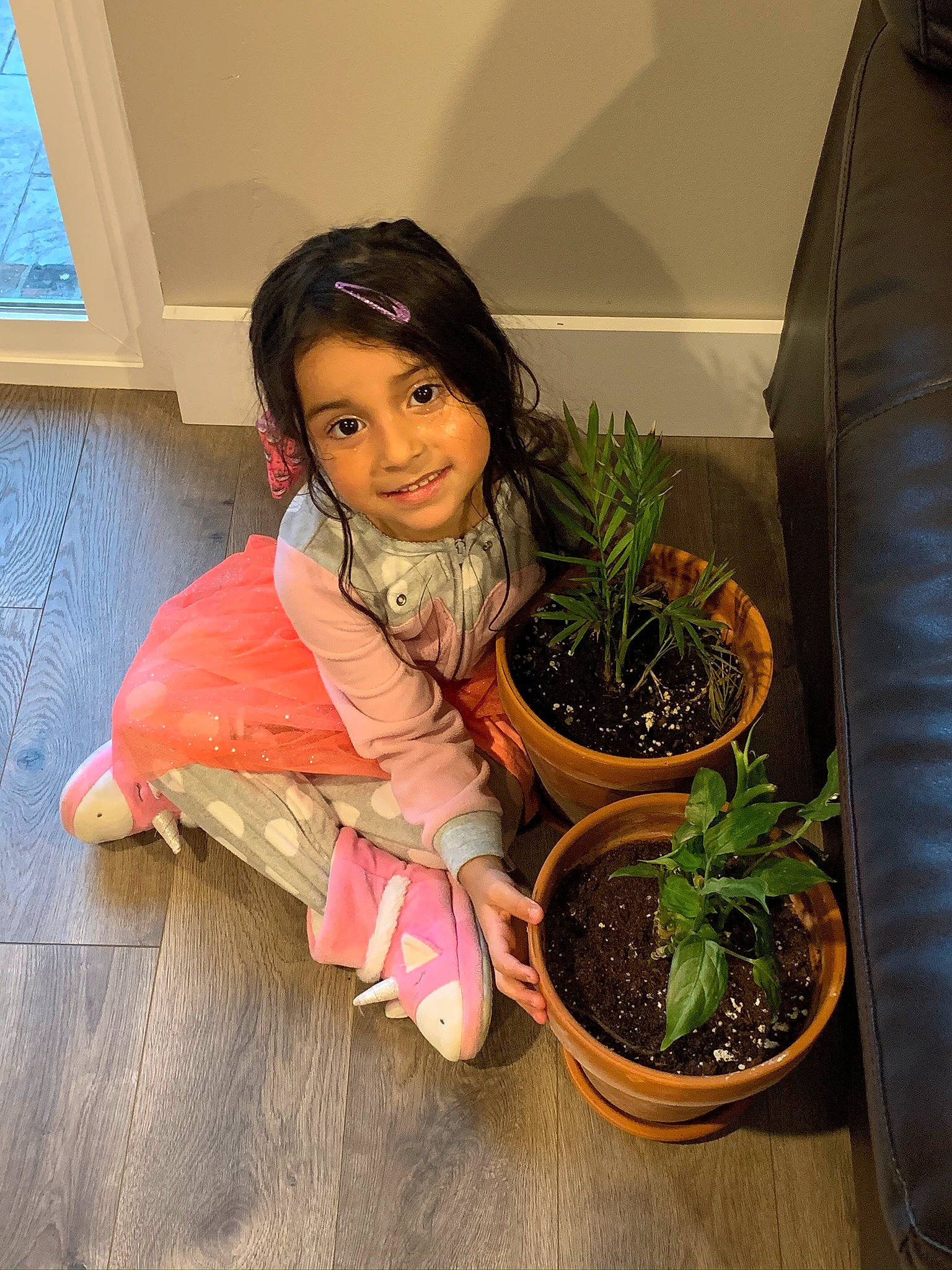 Ailani joined the competition — help win amazing prizes! child, compost, flooring, flower, flowerpot, garden, grass, herb, houseplant, joy, person, plant, plant_stem, room, scarf, sitting, soil, terrestrial_plant, toddler, tree