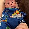 Westen is registered to the contest to win money with this photo: baby, babywear, closeup, clothing, colorful, comfort, couch, face, furniture, hand, human, indoor, infant, newborn, onesie, person, portrait, resting, skin, sleepwear