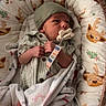 Westen is registered to the contest to win money with this photo: baby, baby_nest, blanket, child, clothing, cozy, cute, deer_pattern, footprints, hand, hat, indoor, infant, newborn, pacifier, resting, sleeping_baby, small, soft, wrapped