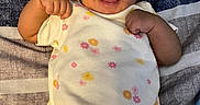 Kelani joined the competition — help win amazing prizes! arms, baby, blanket, child, clothing, cute, expression, face, happy, indoors, infant, lying_down, onesie, pattern, person, portrait, skin, smiling, striped, toddler