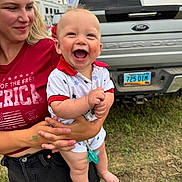 Beau joined the competition — help win amazing prizes! baby, woman, smile, happy, outdoor, grass, truck, ford, license_plate, summer, casual_clothing, holding, child, red_shirt, shorts, pacifier, blue_eyes, light_hair, cheerful, daylight